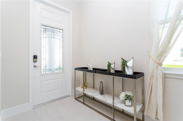 entryway featuring light tile floors and a wealth of natural light