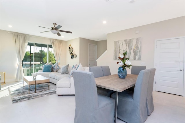 tiled dining space featuring ceiling fan