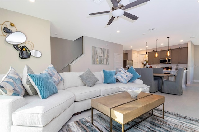 tiled living room featuring ceiling fan