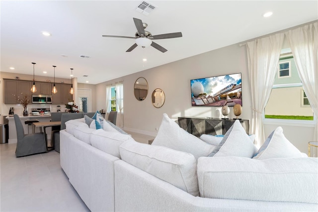 tiled living room featuring ceiling fan