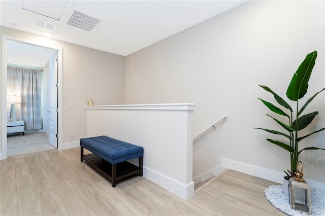 hallway with light hardwood / wood-style floors