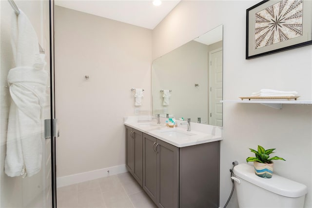 bathroom with toilet, tile floors, and dual vanity