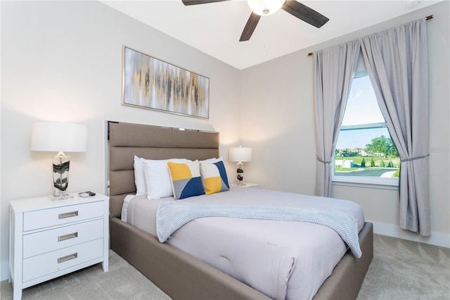 bedroom featuring light carpet and ceiling fan