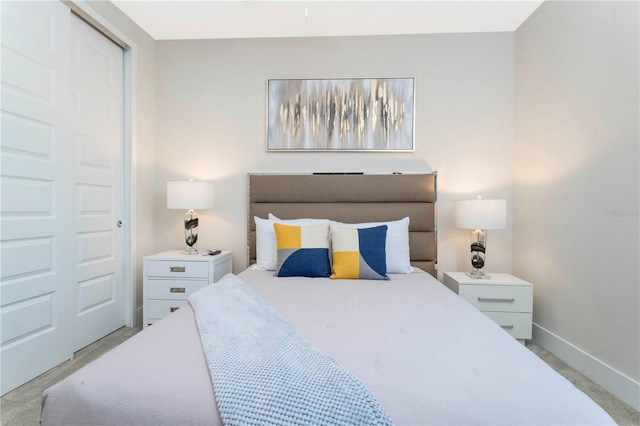 bedroom featuring a closet and light colored carpet