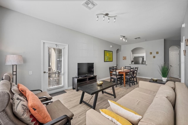 living room featuring track lighting and light hardwood / wood-style flooring