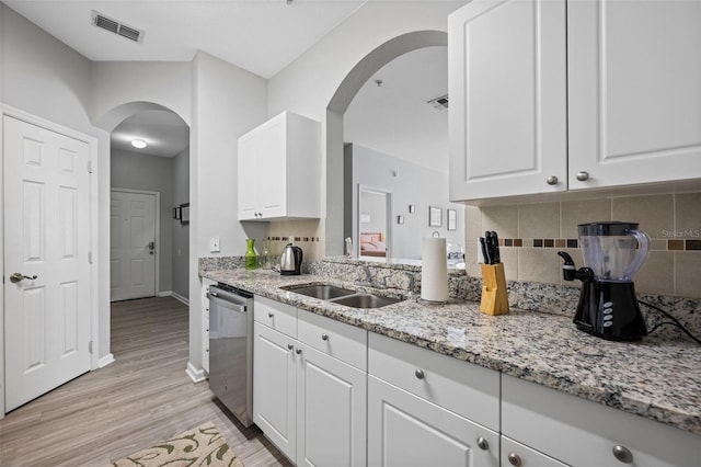 kitchen with backsplash, dishwasher, light hardwood / wood-style flooring, and white cabinetry