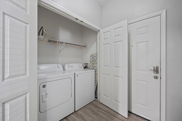 laundry area with hookup for a washing machine, washing machine and clothes dryer, and light wood-type flooring