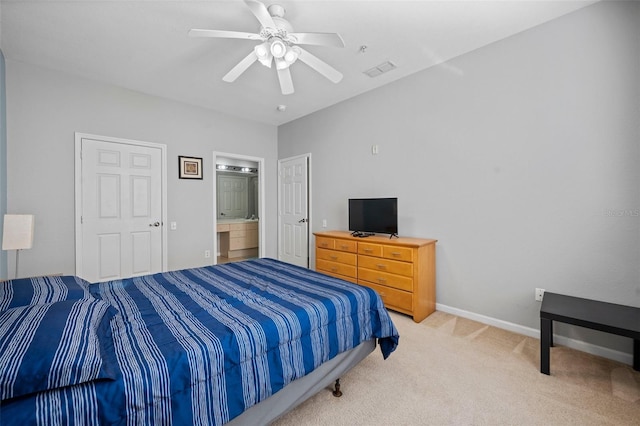 bedroom featuring light colored carpet, connected bathroom, and ceiling fan