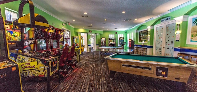 recreation room featuring billiards, ornamental molding, and a textured ceiling