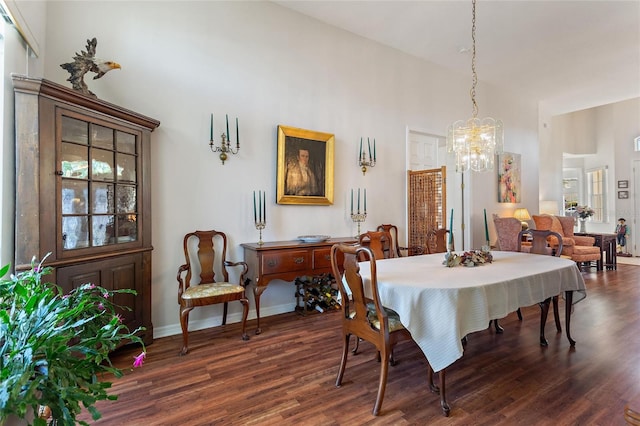 dining space featuring dark hardwood / wood-style flooring and a notable chandelier