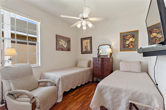 bedroom with ceiling fan and dark hardwood / wood-style flooring