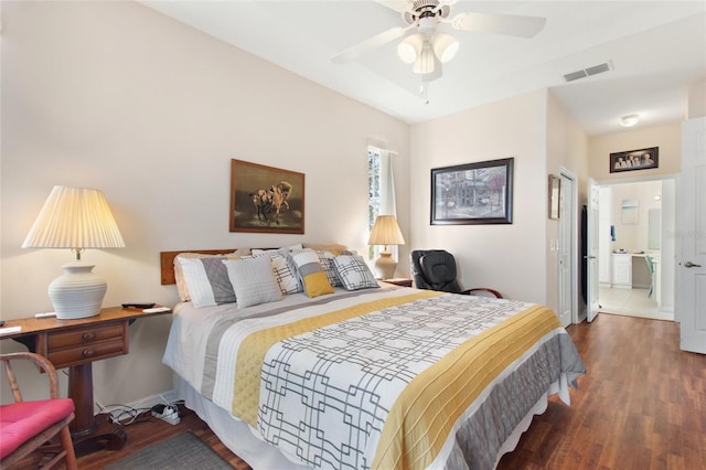 bedroom featuring connected bathroom, dark hardwood / wood-style flooring, and ceiling fan