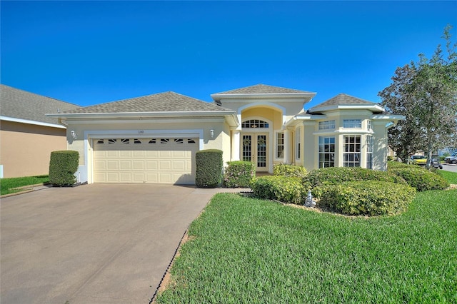 view of front of property featuring a front lawn and a garage