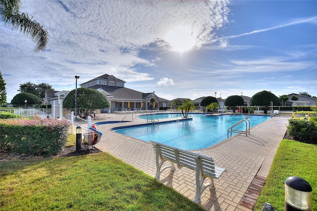 view of swimming pool with a lawn and a patio