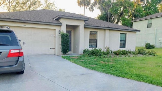 view of front facade with a front yard and a garage