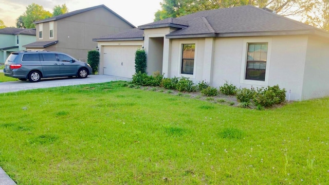 view of front of home with a front yard and a garage