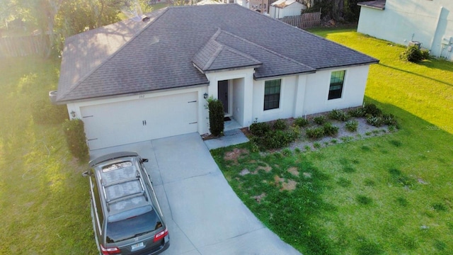 view of front facade featuring a front yard and a garage