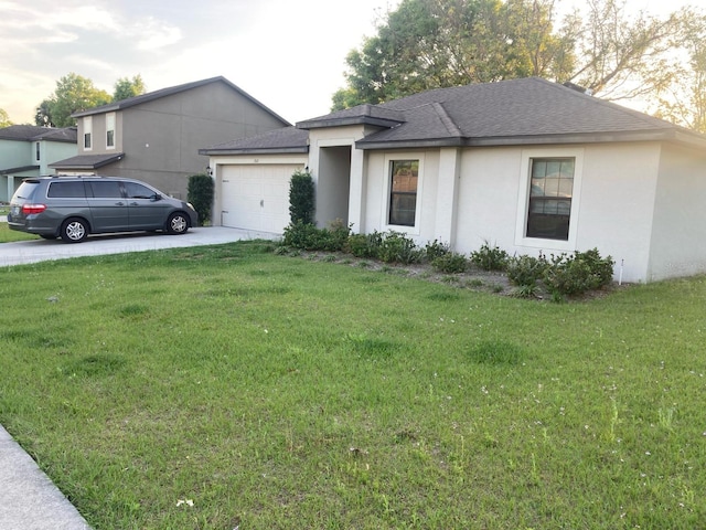 view of front of property featuring a front yard and a garage