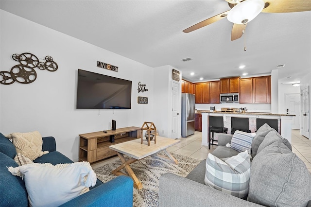 tiled living room featuring ceiling fan