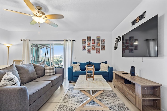 living room featuring light tile flooring and ceiling fan