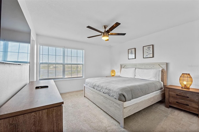 bedroom featuring light carpet and ceiling fan