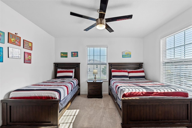 bedroom featuring ceiling fan and light colored carpet