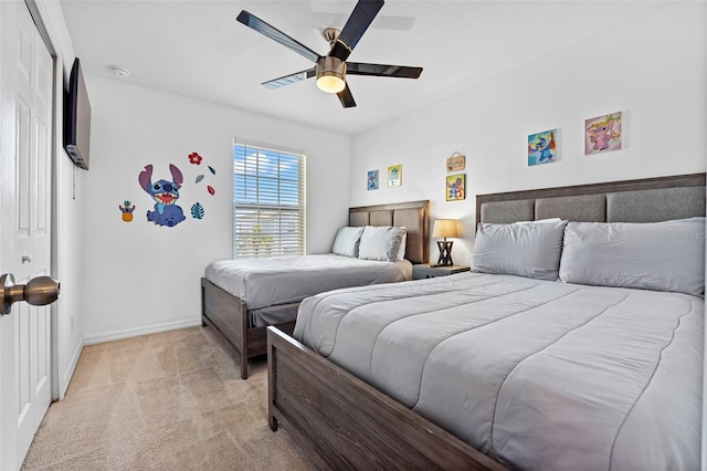 bedroom featuring light carpet and ceiling fan