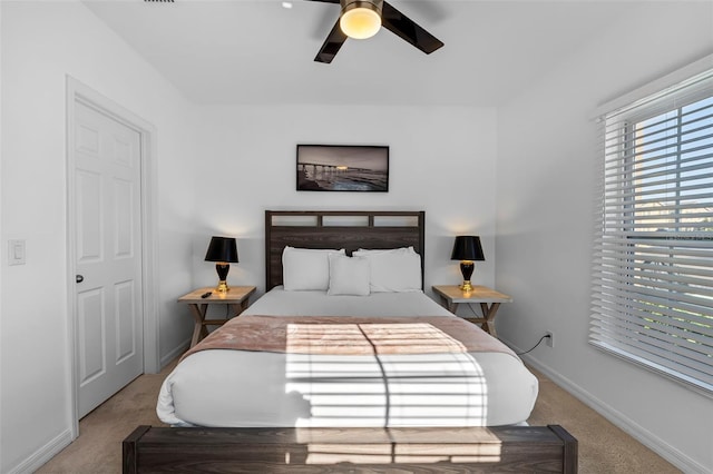 bedroom with light colored carpet and ceiling fan