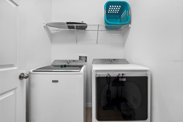 laundry area featuring hookup for a washing machine and separate washer and dryer