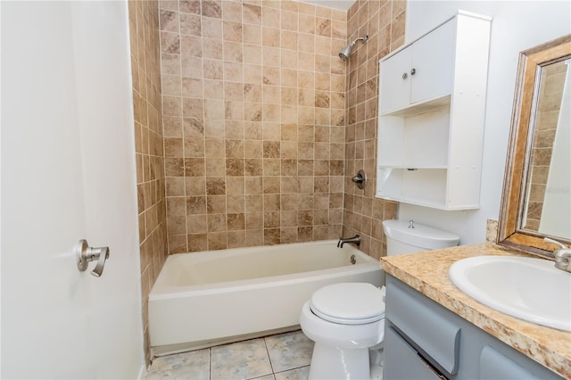 full bathroom with tile patterned floors, vanity, tiled shower / bath combo, and toilet