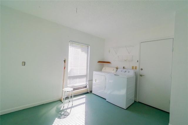 clothes washing area with washer and clothes dryer