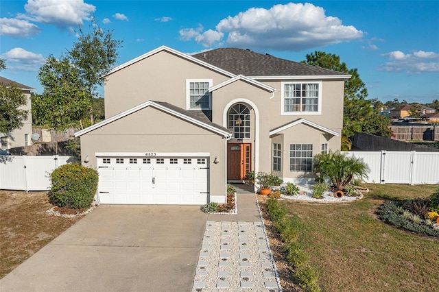 view of front property featuring a front yard and a garage