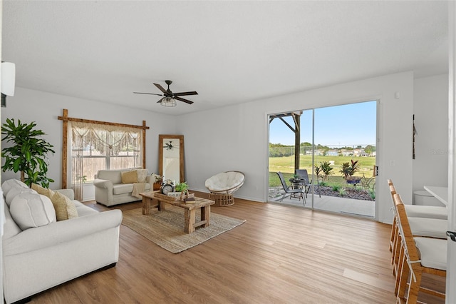 living room featuring light hardwood / wood-style floors and ceiling fan