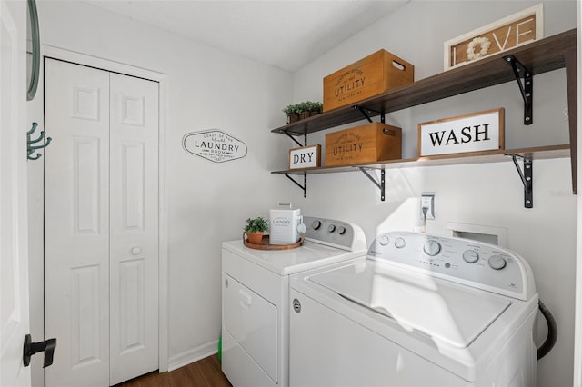 laundry room featuring dark wood-type flooring and washer and dryer