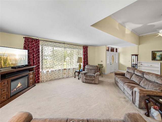 living room featuring carpet flooring, ceiling fan, and crown molding