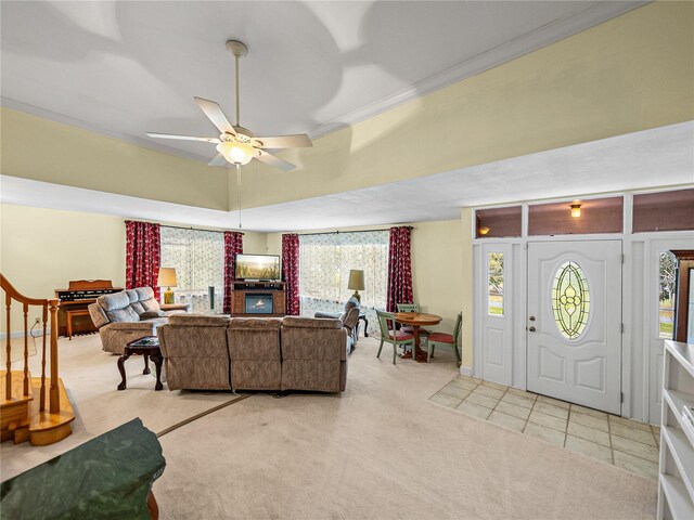 carpeted living room featuring crown molding, ceiling fan, and brick wall