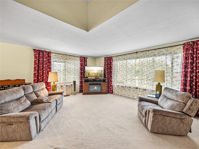 living room featuring light carpet, a fireplace, and a wealth of natural light