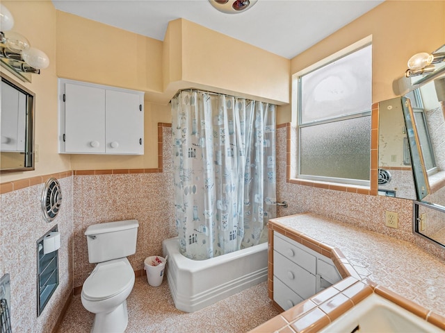 full bathroom with toilet, vanity, tasteful backsplash, tile walls, and shower / tub combo with curtain