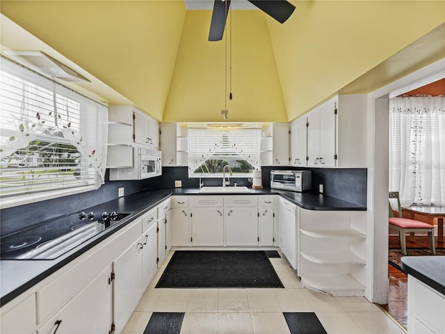 kitchen with a healthy amount of sunlight, ceiling fan, light tile floors, and tasteful backsplash