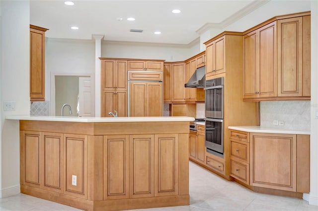 kitchen featuring visible vents, light countertops, a peninsula, paneled built in refrigerator, and under cabinet range hood