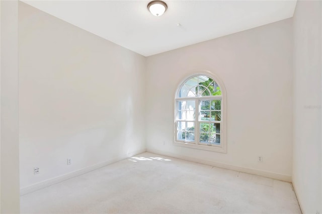 empty room with light carpet and baseboards