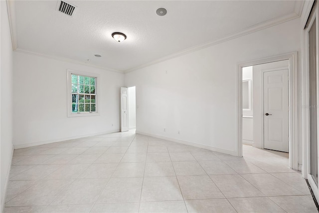 unfurnished room featuring crown molding, a textured ceiling, baseboards, light tile patterned floors, and visible vents