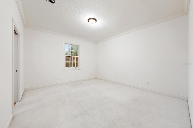 spare room featuring crown molding, baseboards, carpet, and a textured ceiling
