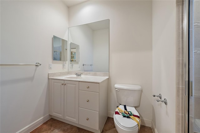 full bath featuring vanity, baseboards, tile patterned floors, and toilet