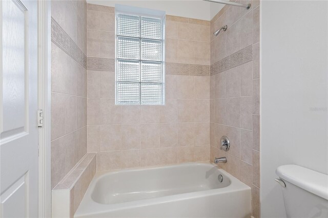 bathroom featuring toilet, shower / tub combination, and a wealth of natural light