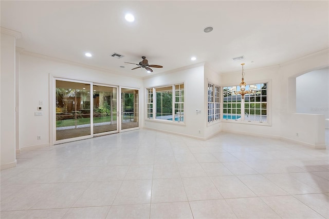 empty room with crown molding, visible vents, baseboards, arched walkways, and ceiling fan with notable chandelier