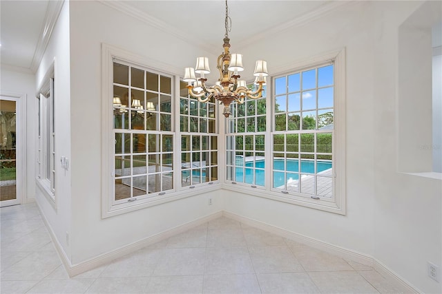 unfurnished dining area featuring crown molding, baseboards, tile patterned flooring, and a notable chandelier