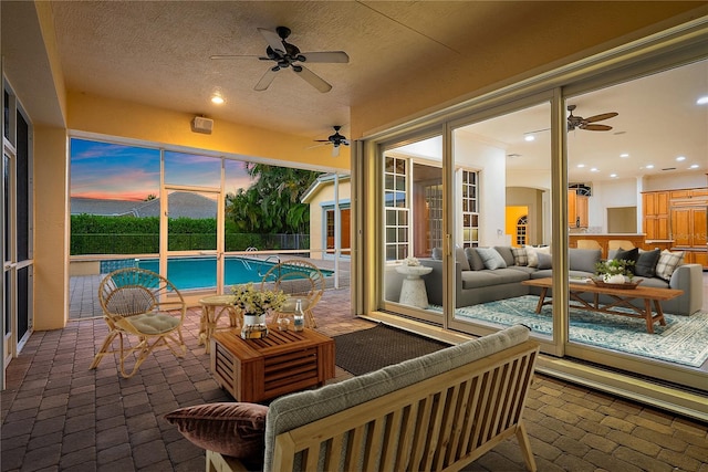 exterior space with an outbuilding, outdoor lounge area, a ceiling fan, and a fenced in pool