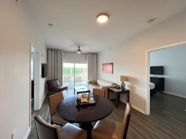 dining area featuring dark wood-type flooring and ceiling fan