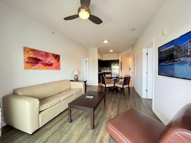 living room featuring ceiling fan and hardwood / wood-style flooring